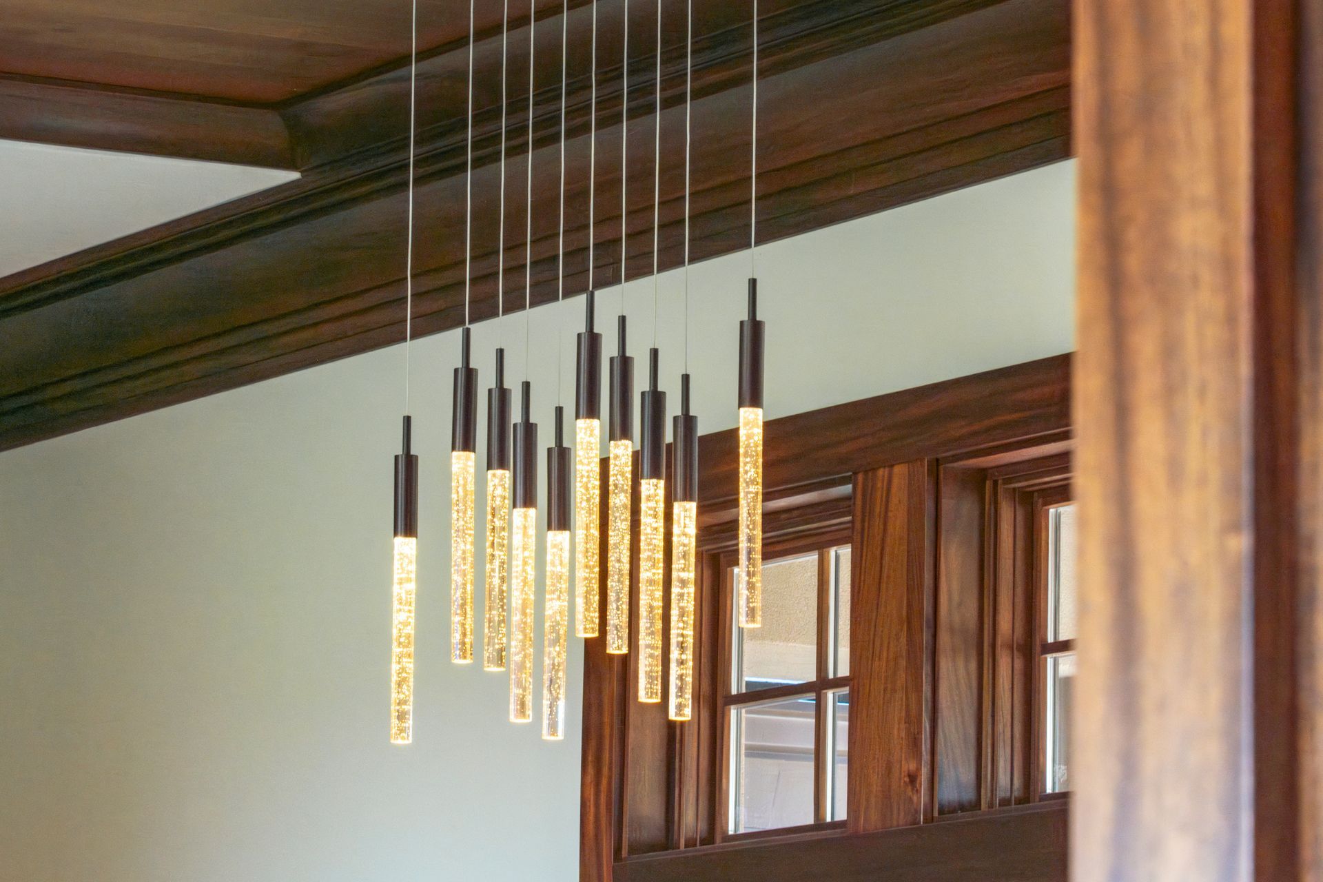 A bunch of lights are hanging from the ceiling in a room.