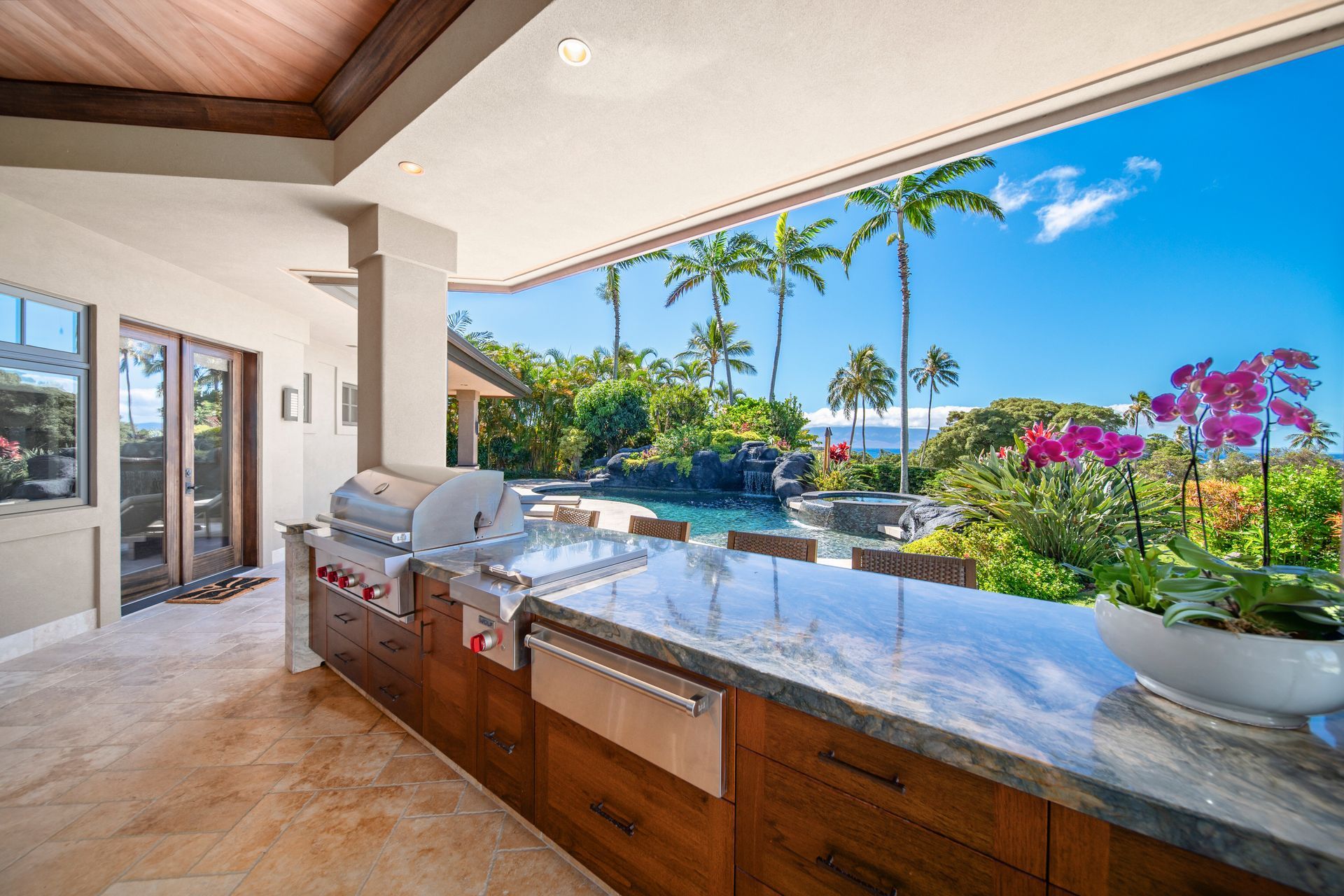 A kitchen with a grill and a view of the ocean