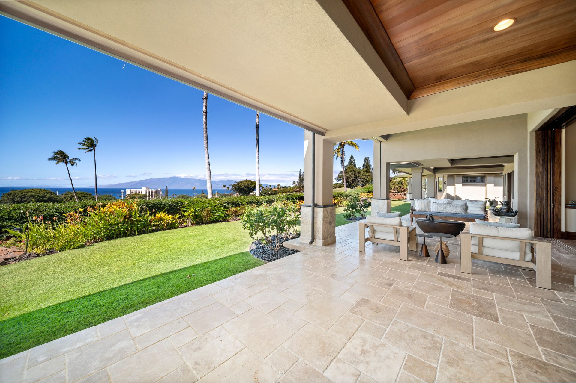 A large patio with a view of the ocean and mountains