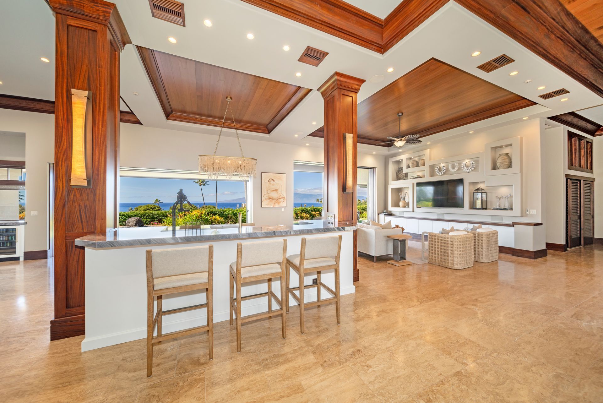 A large room with a bar and chairs in it