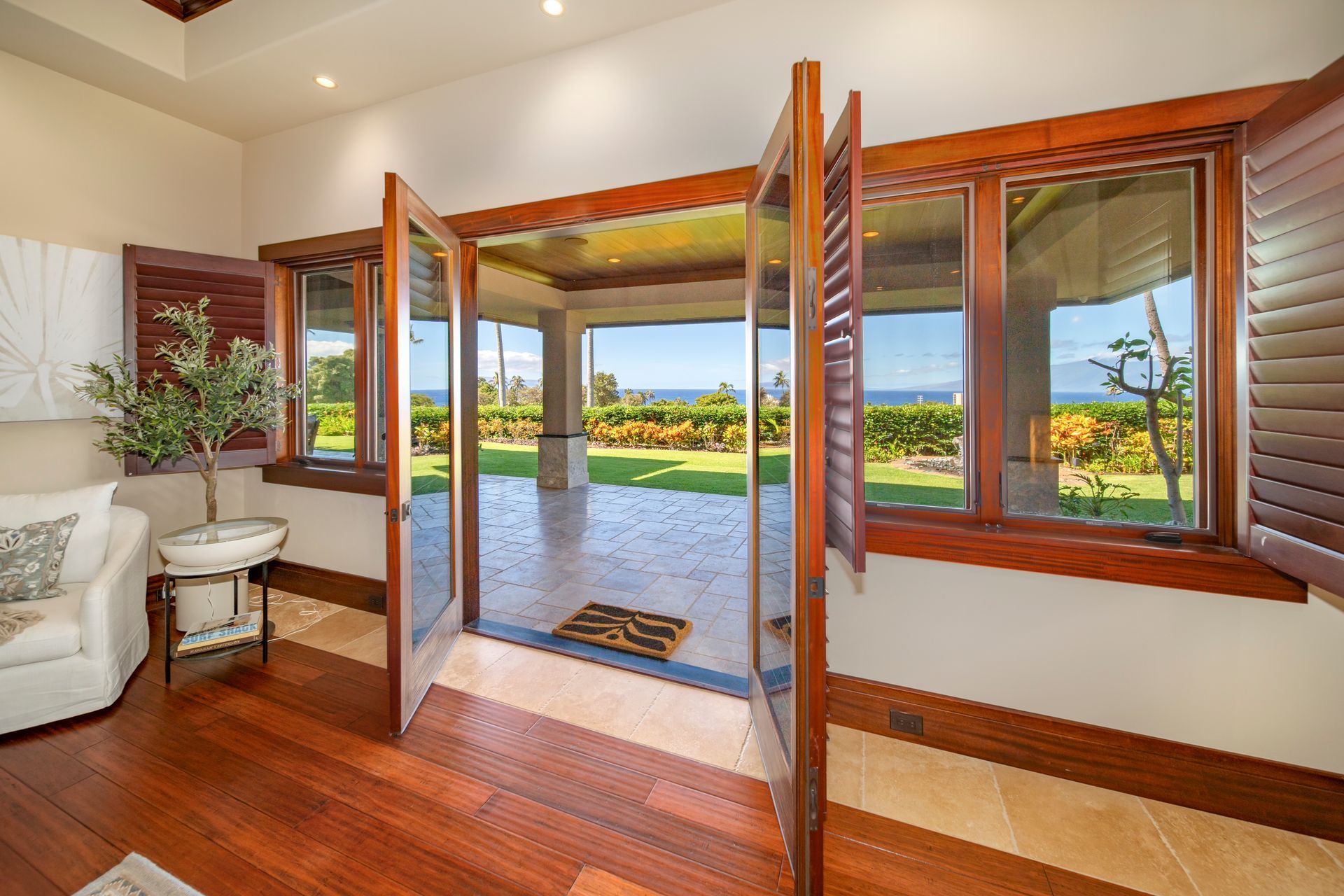 A living room with hardwood floors and lots of windows
