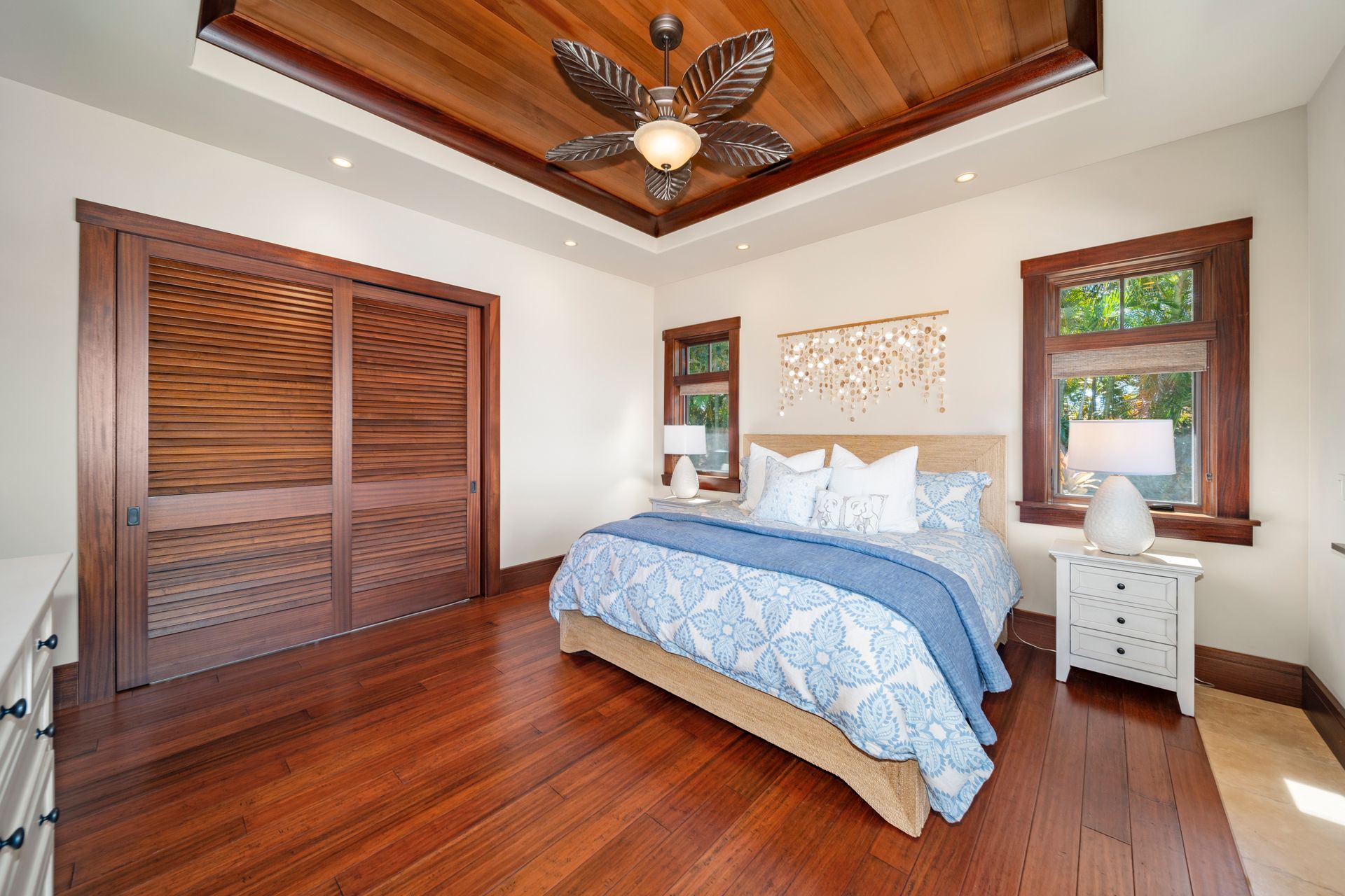 A bedroom with a bed and a ceiling fan
