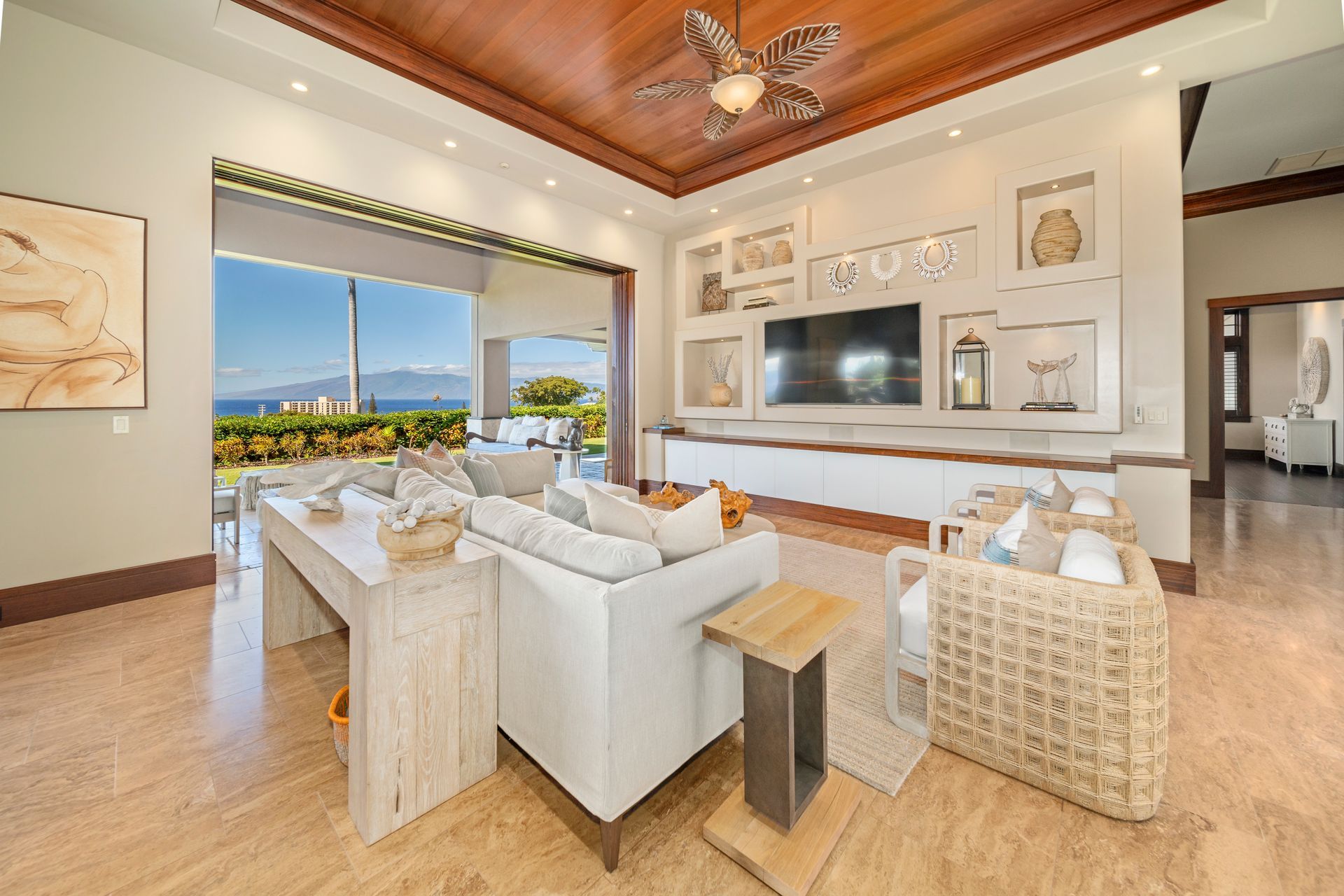 A living room with a couch , chair , table and television.