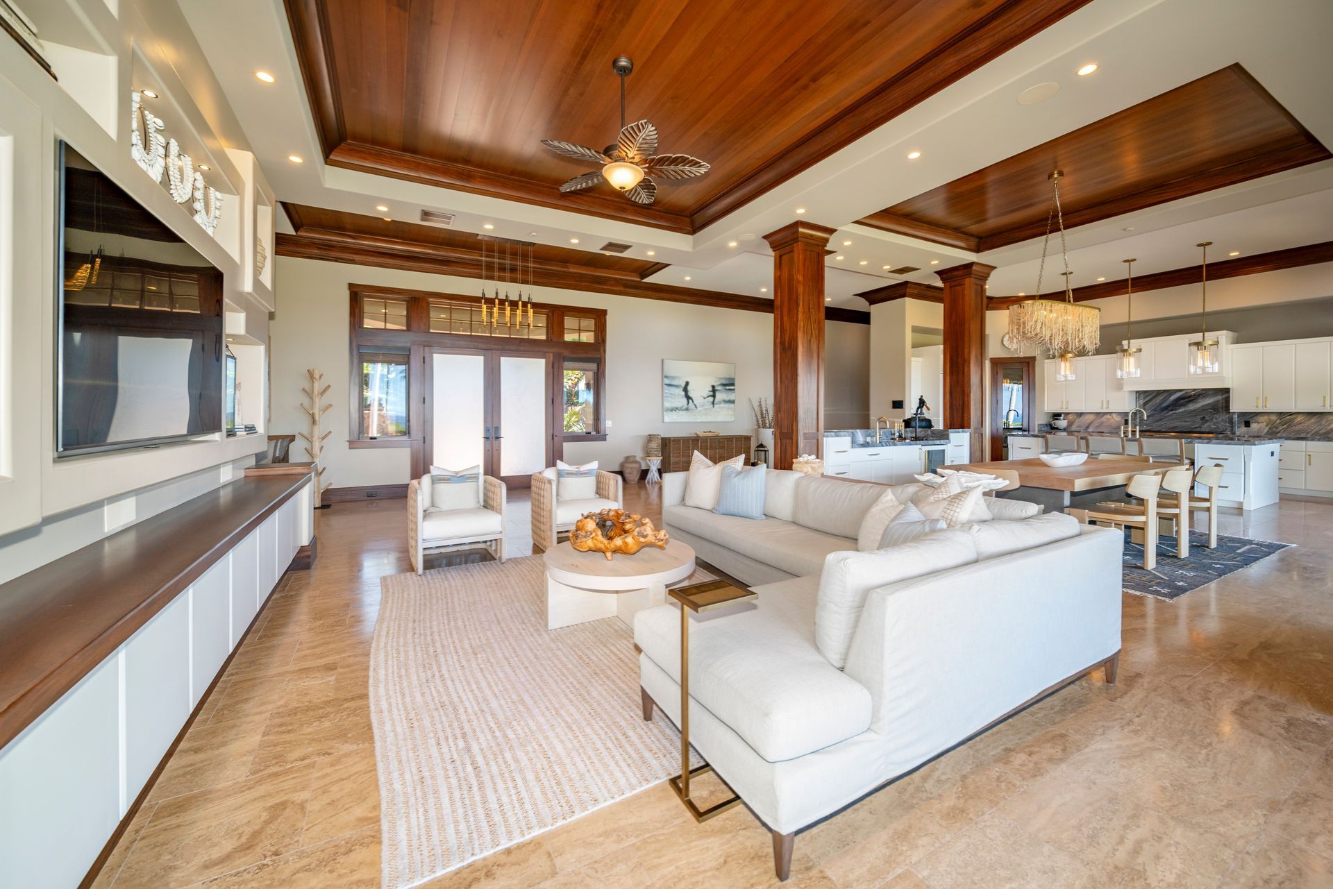 A living room with a couch , chairs , table and television.