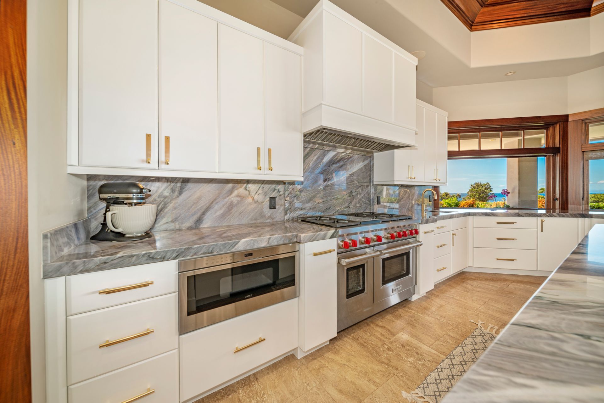 A kitchen with white cabinets and stainless steel appliances.