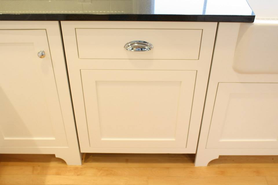 White kitchen cabinet with a drawer and a cabinet door.