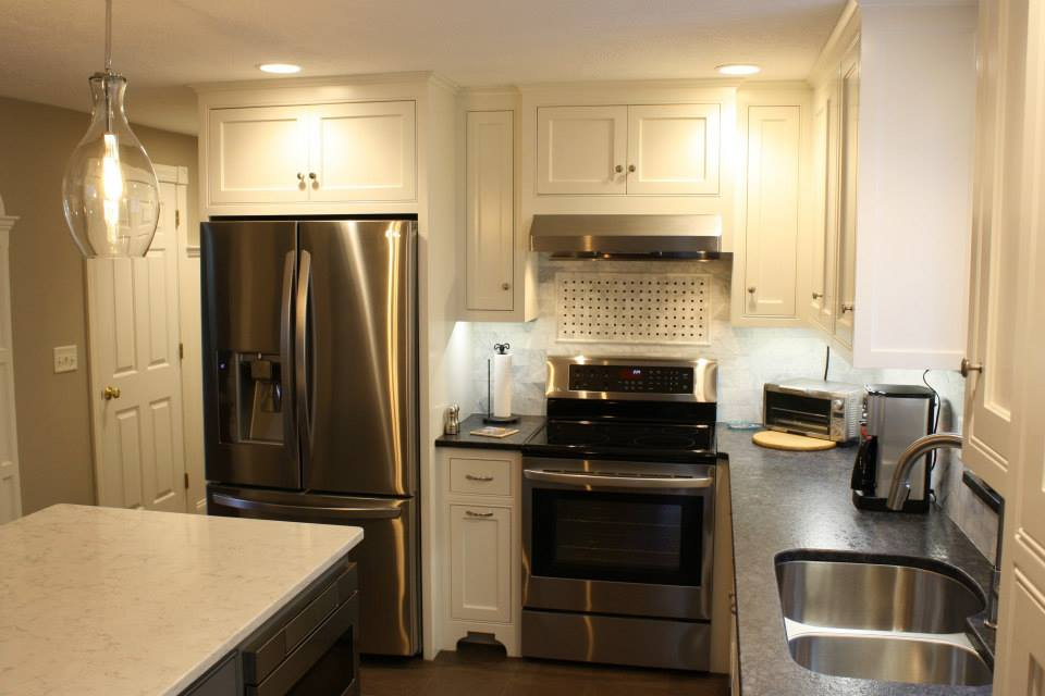 Kitchen with white cabinets, stainless steel appliances, and dark countertops.