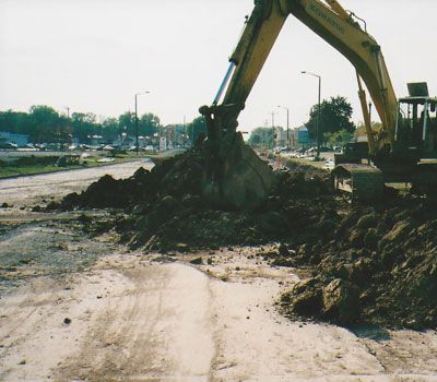 A komatsu excavator is digging a pile of dirt