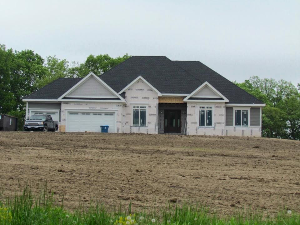 a house that is being built in a field