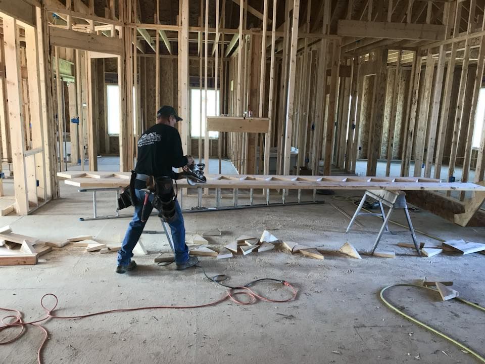 a man is using a circular saw in a room under construction .