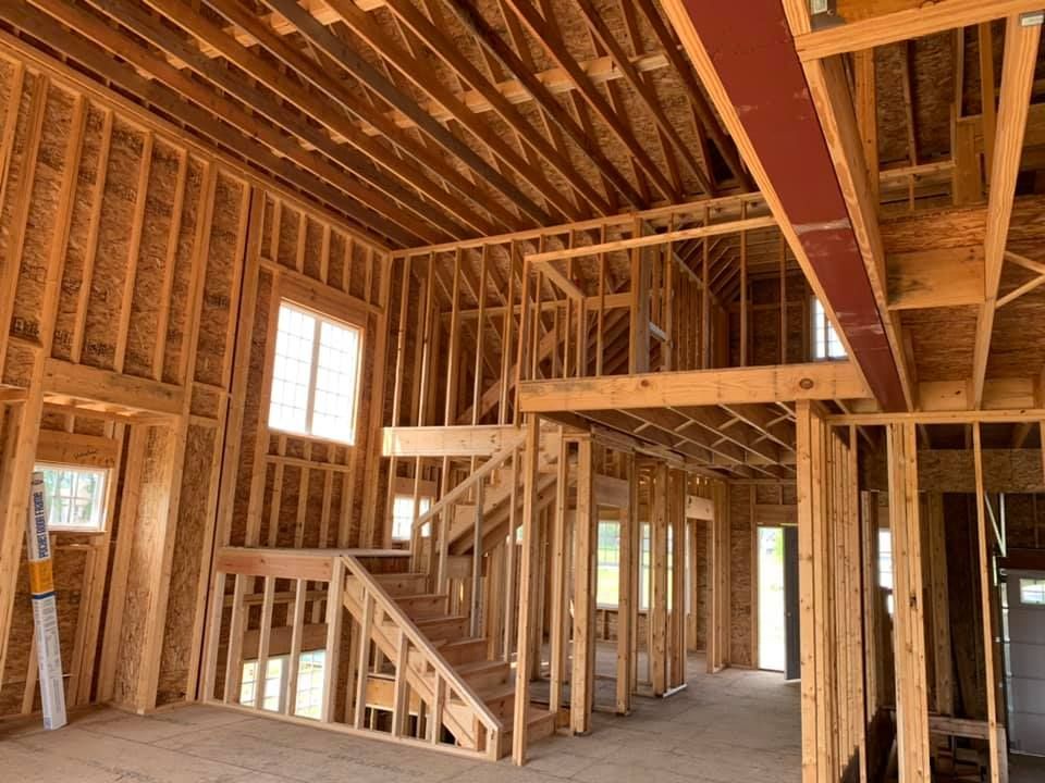 an empty living room with a fireplace and shelves
