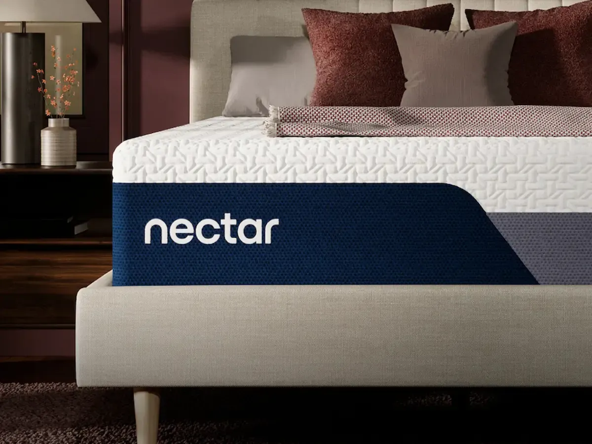 Nectar mattress in a modern bedroom with pillows and a bedside lamp