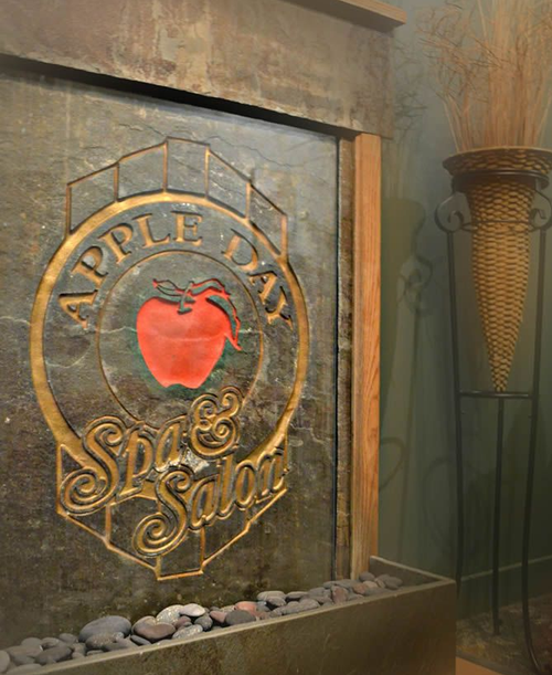 Woman with smooth skin, rests arms on a surface, looking at the camera.