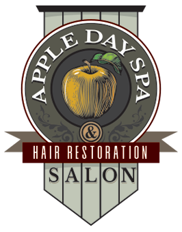 Apple Day Spa logo: Yellow apple with a leaf, surrounded by text 