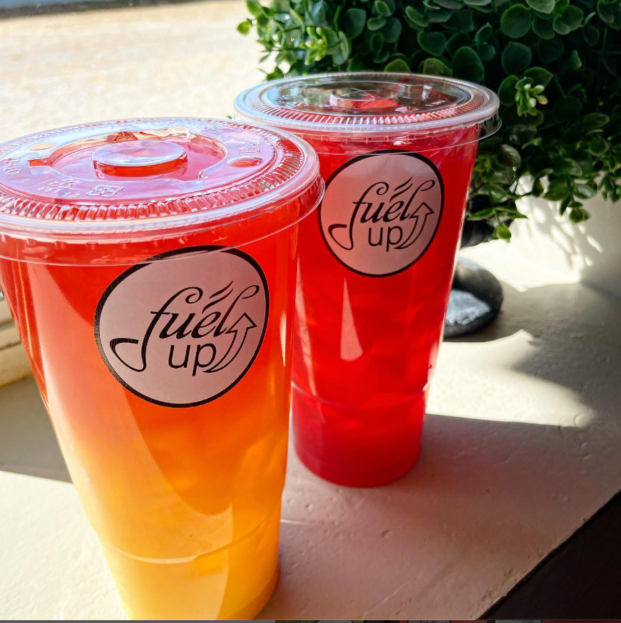 Two cups of fuel up sit on a table