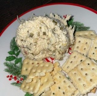 A plate with crackers and a ball of food on it