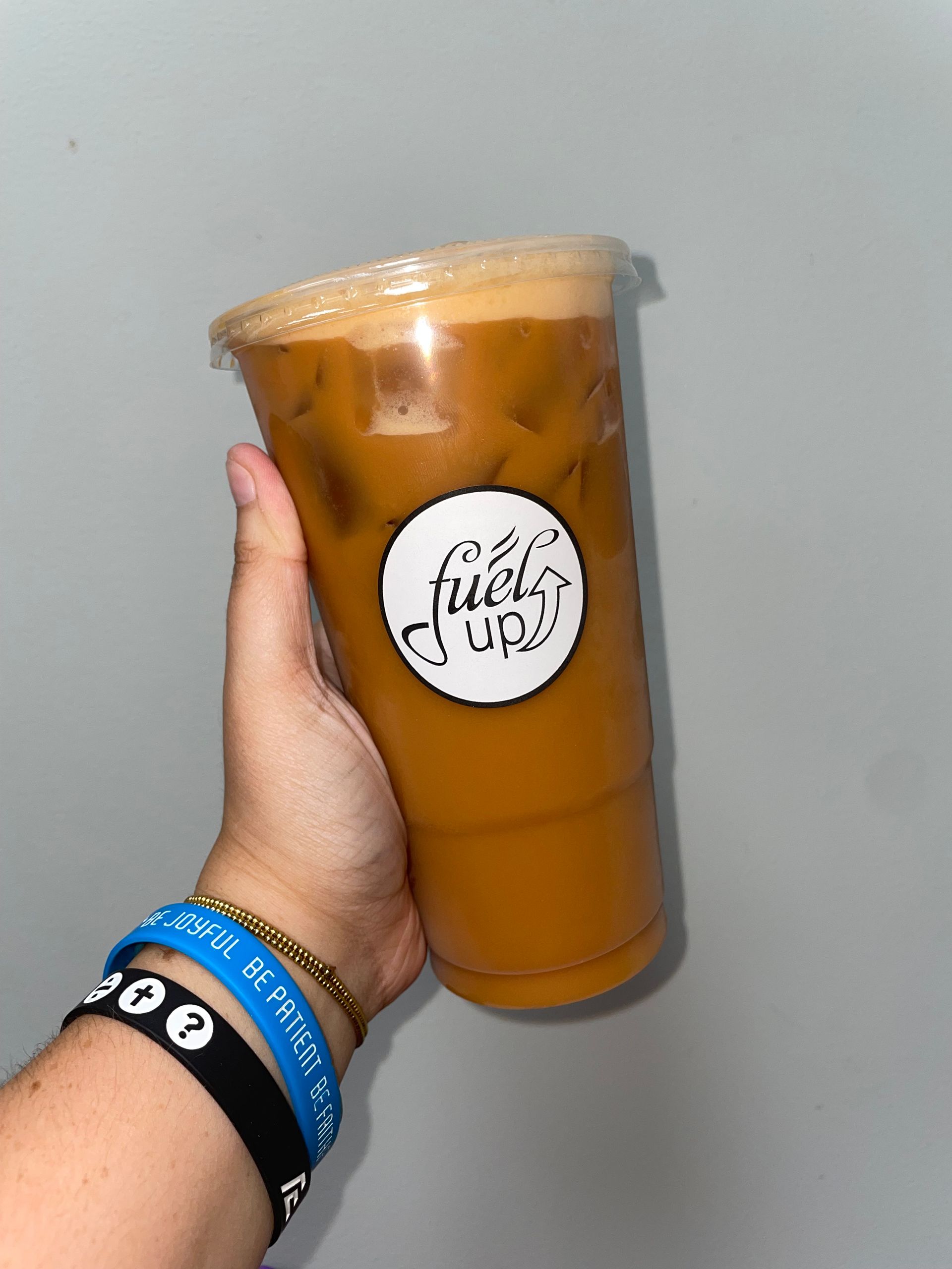 A person is holding a cup of coffee in their hand.