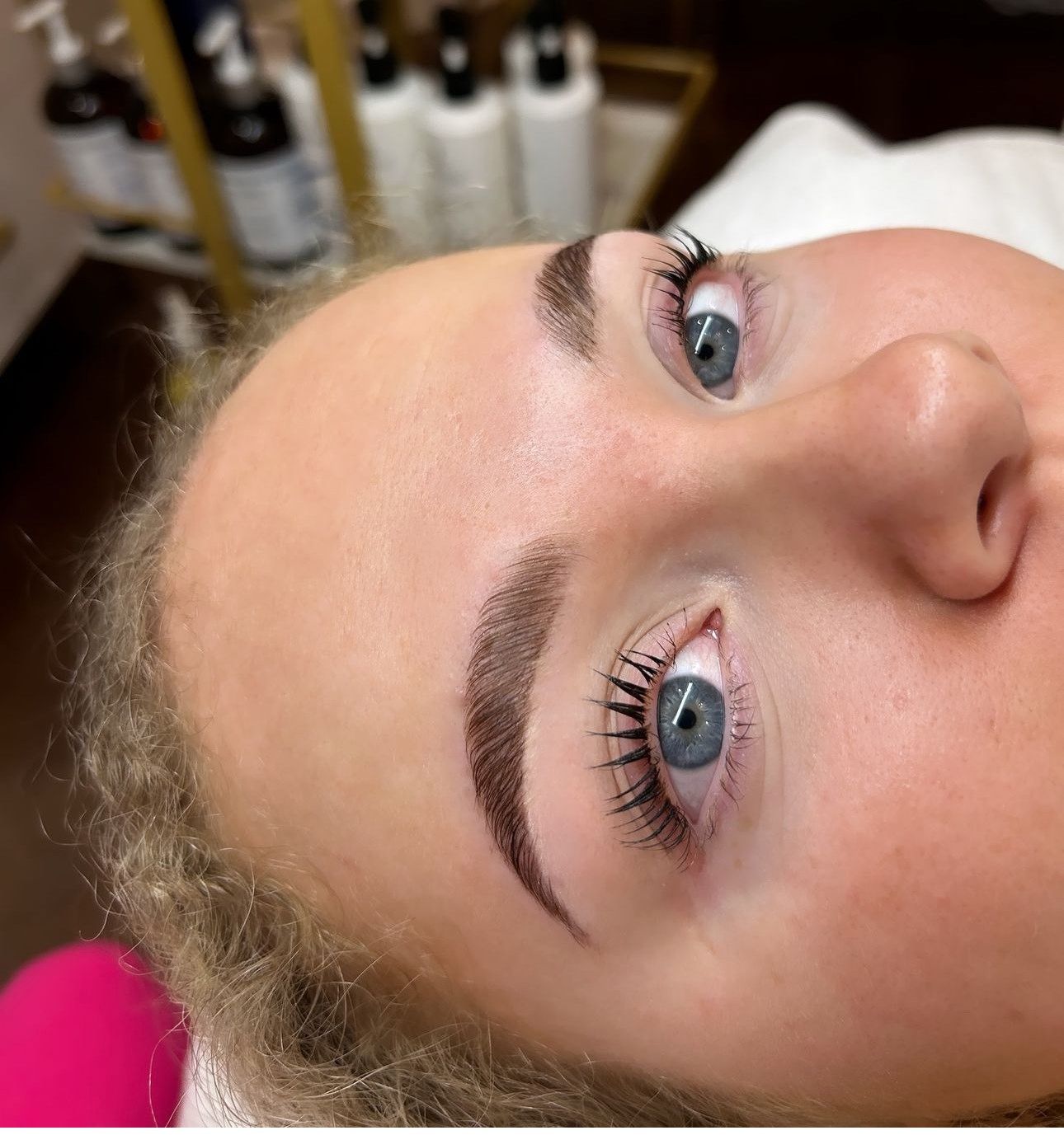 A close up of a woman 's face with blue eyes