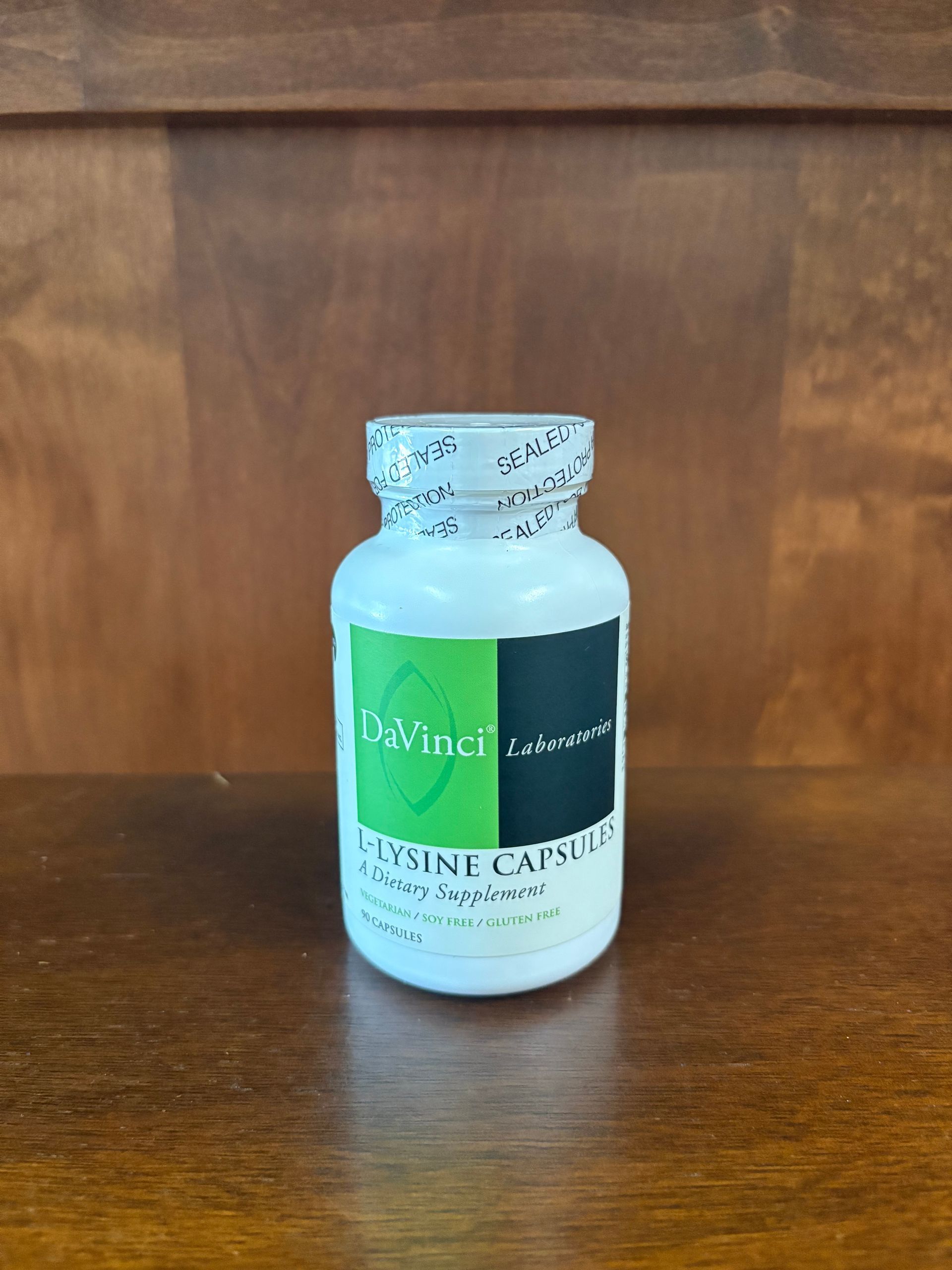 A bottle of lyme capsules is sitting on a wooden table.