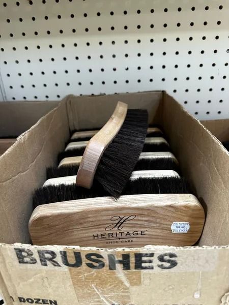 Cardboard box of Heritage brushes with black-and-white bristles on a store shelf