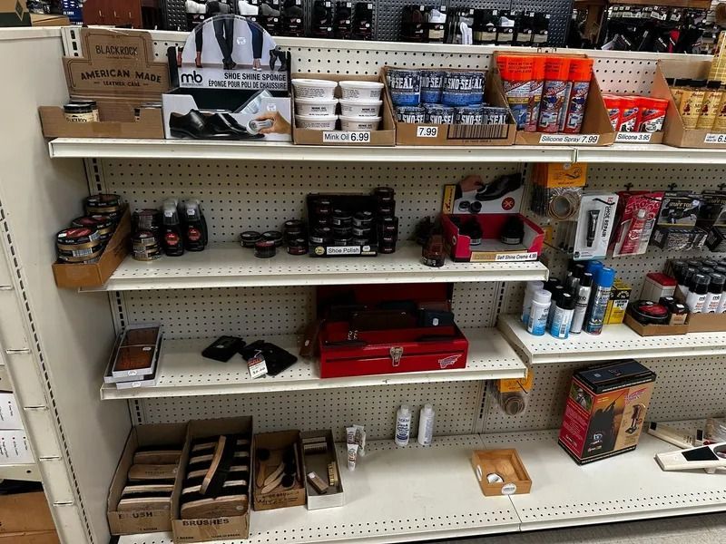 Store shelf stocked with assorted snack and drink boxes, cans, and small items