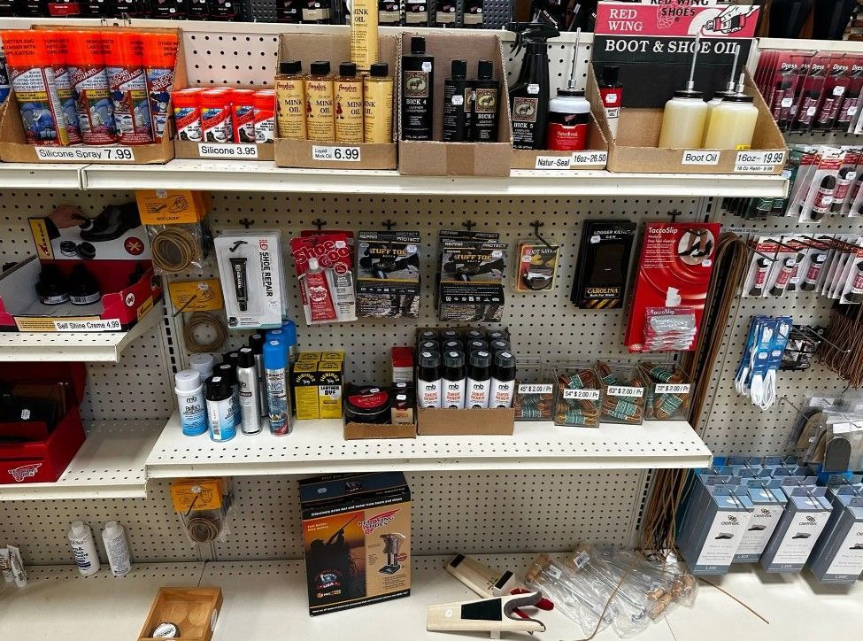 Store shelf stocked with assorted bottles, cans, and boxed products in a retail aisle.