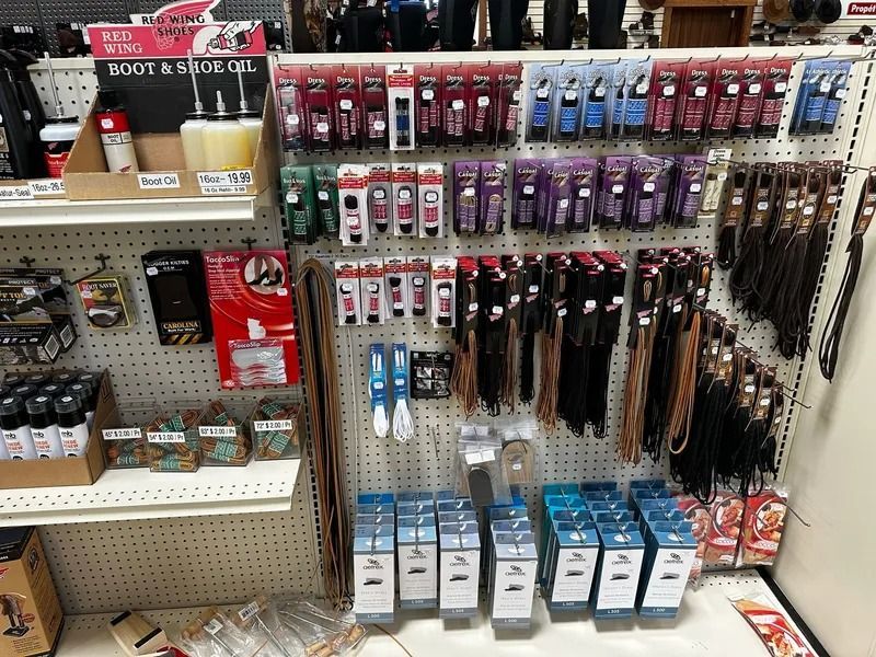 Store aisle display of packaged hair accessories in red, purple, blue, and black on pegboard hooks.
