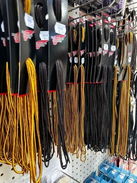 Assorted black and yellow cable ties hanging on a store display rack