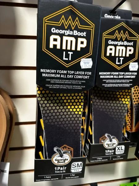 Georgia Boot AMP LT memory foam boot insoles on retail display, black and yellow packaging