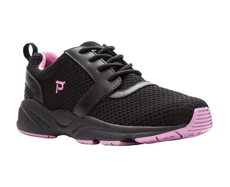 Black athletic sneaker with pink accents and pink sole
