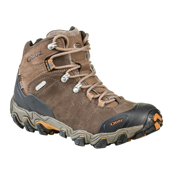 Brown and gray hiking boot with orange accents and rugged sole on a white background