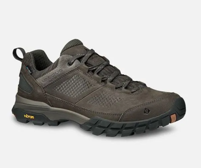 Brown low-cut hiking shoe with rugged sole on a white background