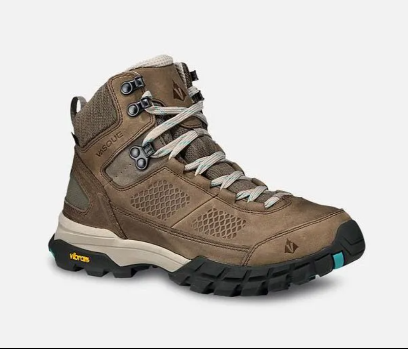 Brown hiking boot with black sole and light gray laces on a white background