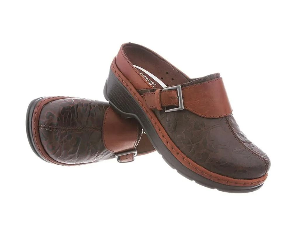 Pair of brown leather clogs with a strap and buckle on a white background