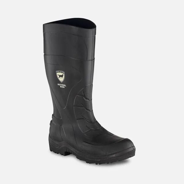 Black knee-high rubber work boot with rugged tread sole on a white background