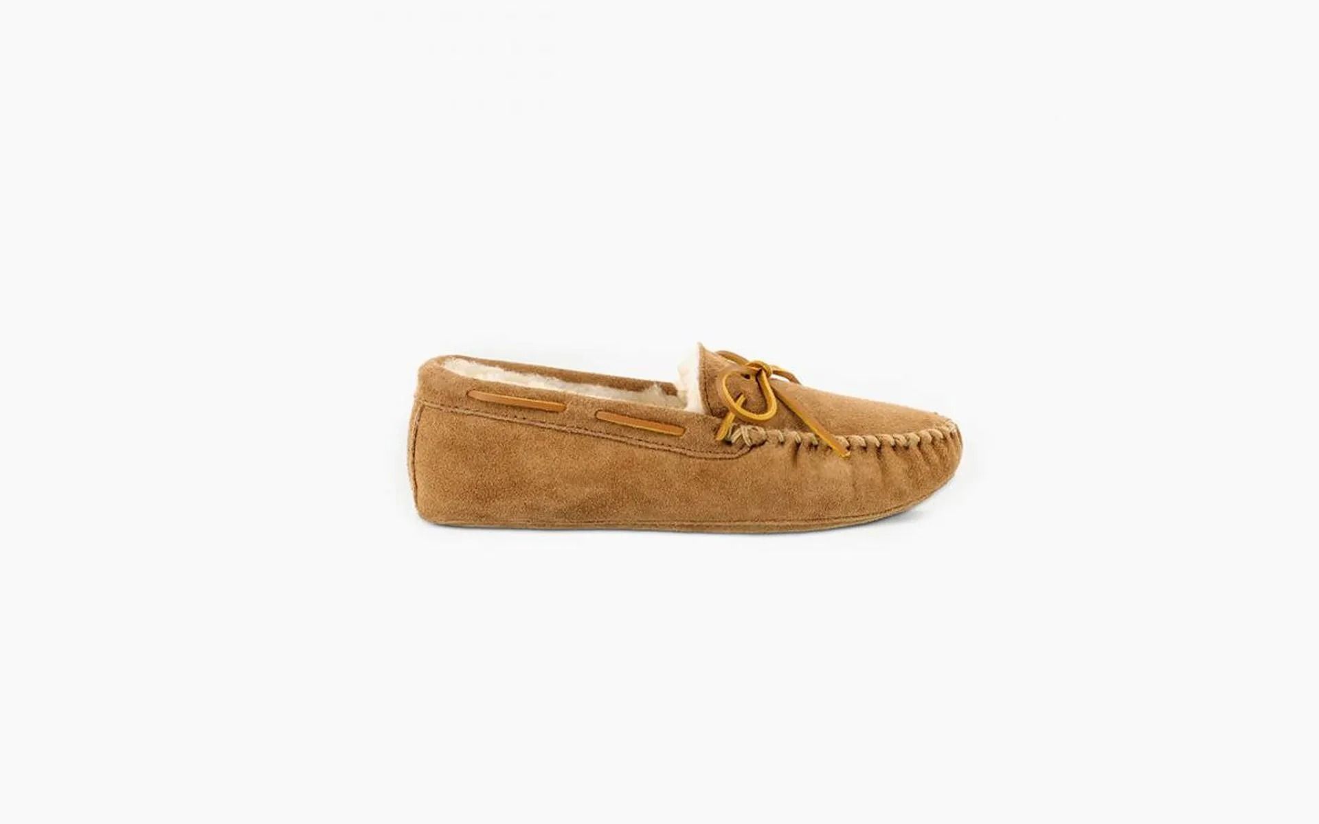 Tan suede slip-on loafer with moccasin stitching on a white background