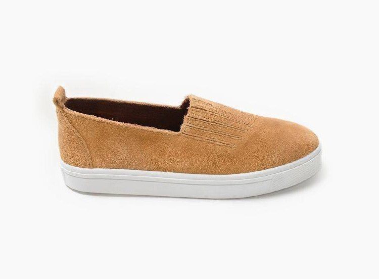 Tan slip-on sneaker with white sole on a white background