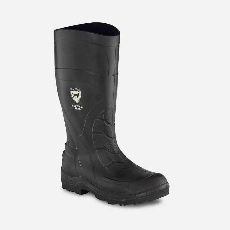 Black knee-high work boot with thick tread sole on a white background
