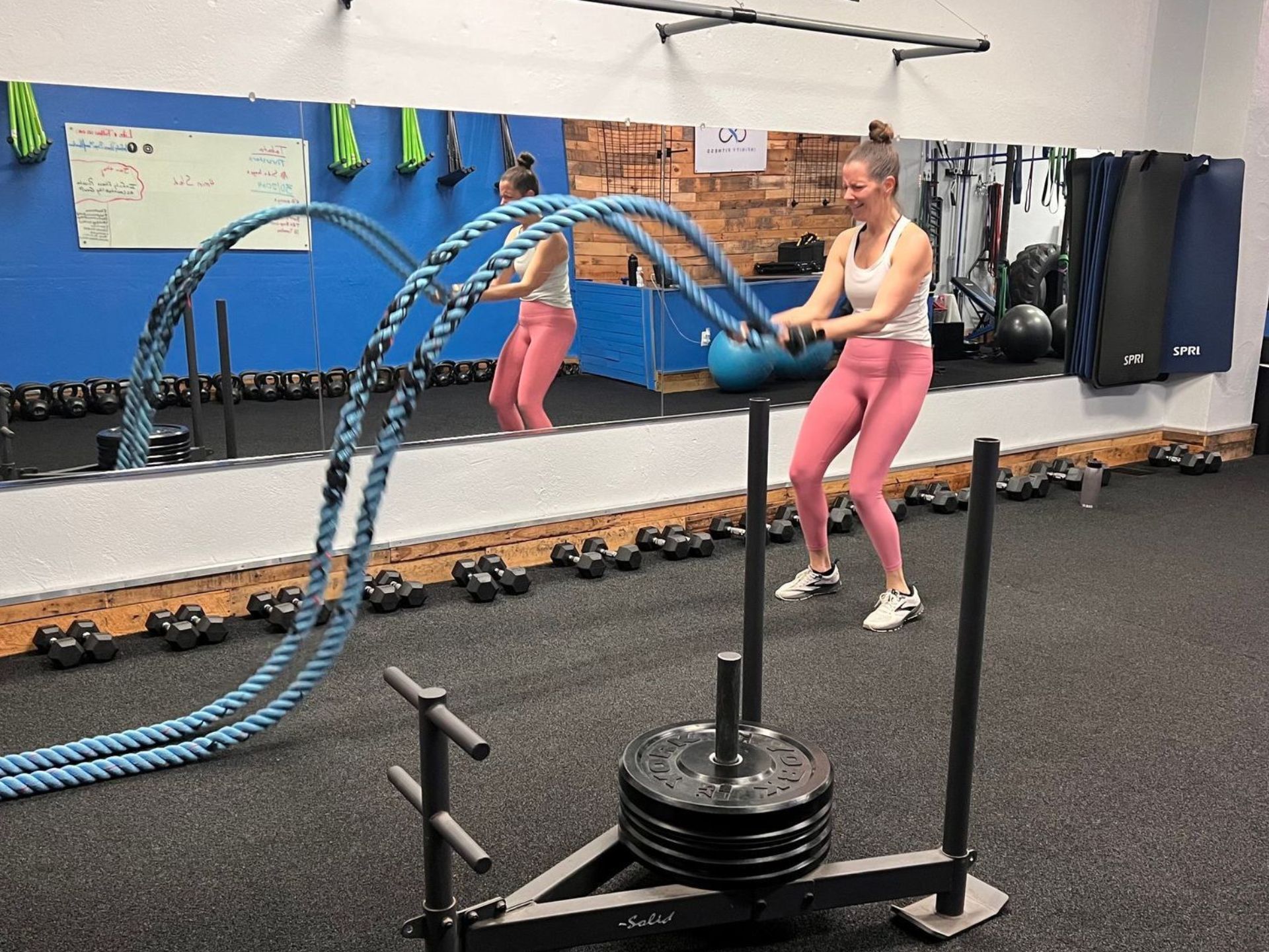 infinity fitness front of building painted windows and flowers in front