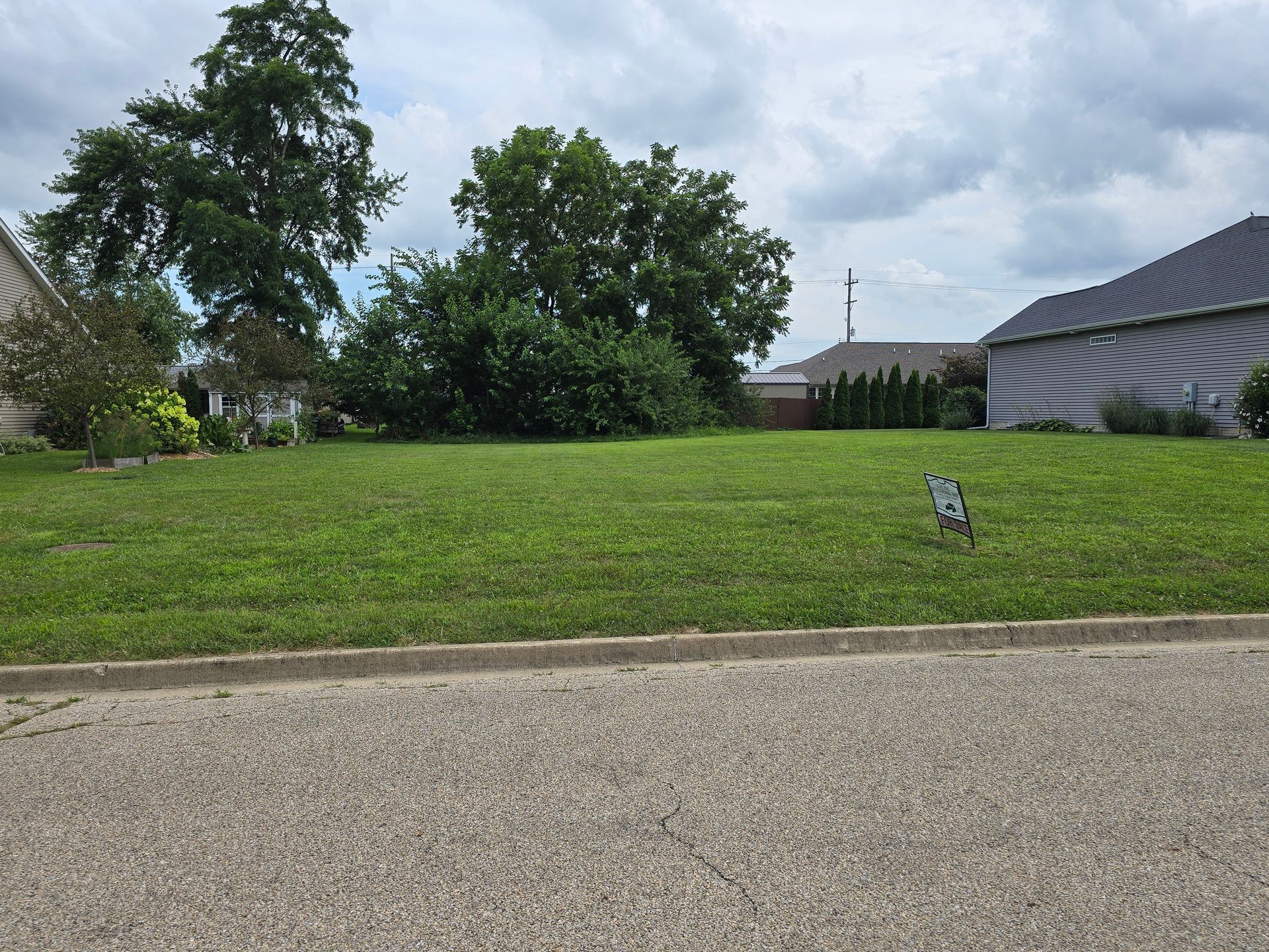 A lawn with a bench in the middle of it