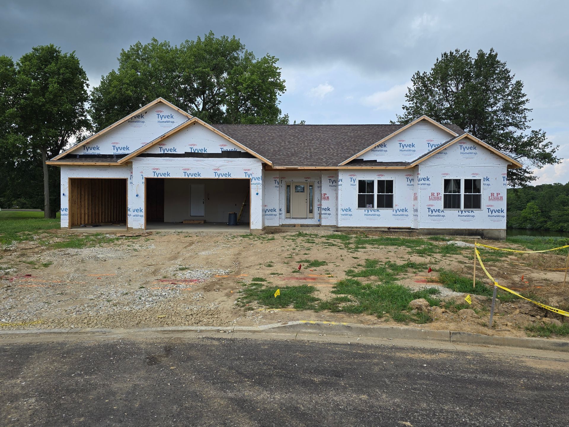A house is being built in the middle of a dirt field.