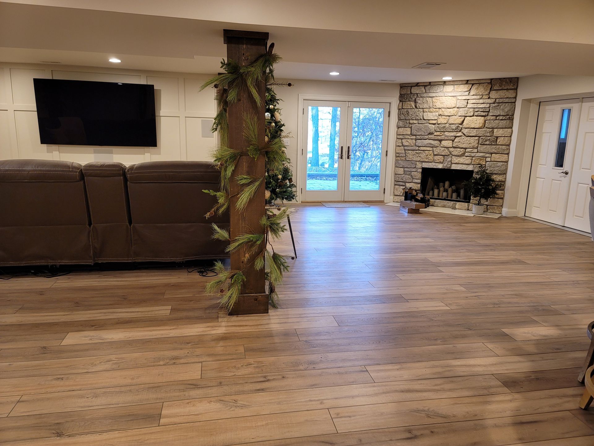 A living room with a couch , fireplace and television.