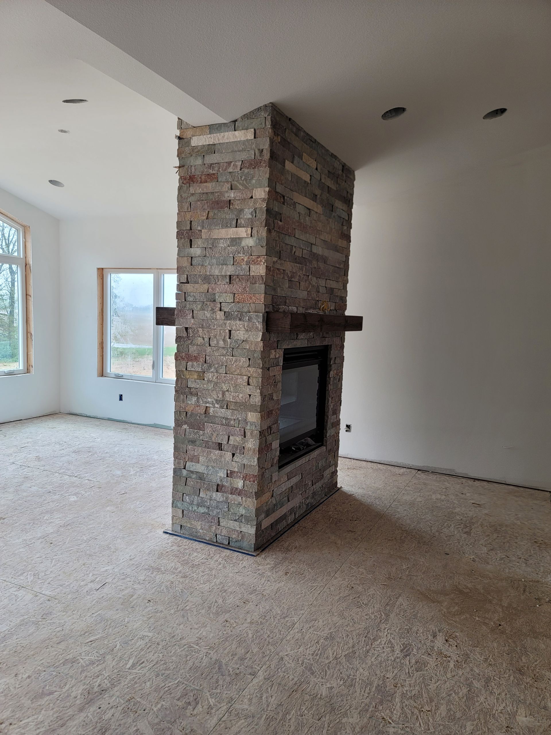 There is a fireplace in the middle of the room.