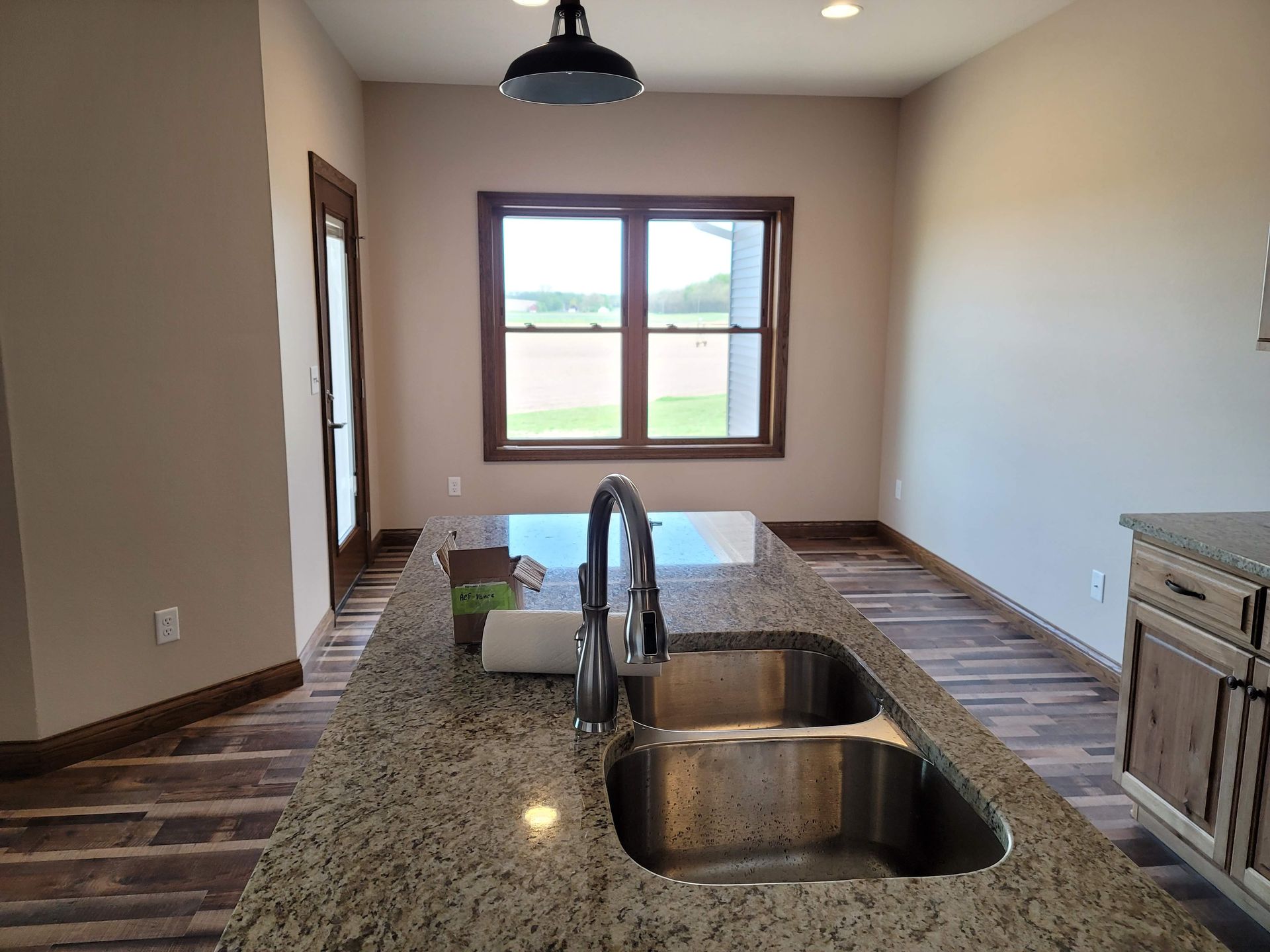 A kitchen with two sinks and a large window