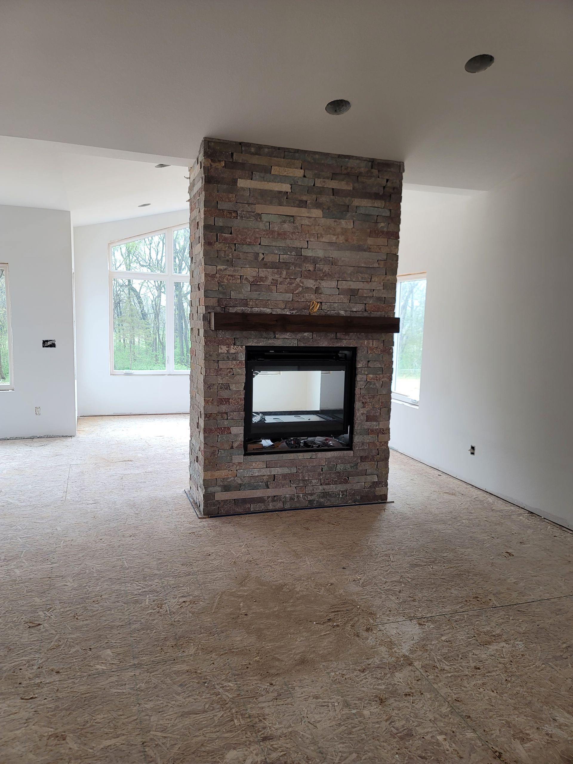There is a fireplace in the middle of the room.