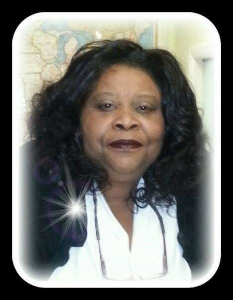 Woman with dark hair and a white shirt, smiling; a starburst effect is present.