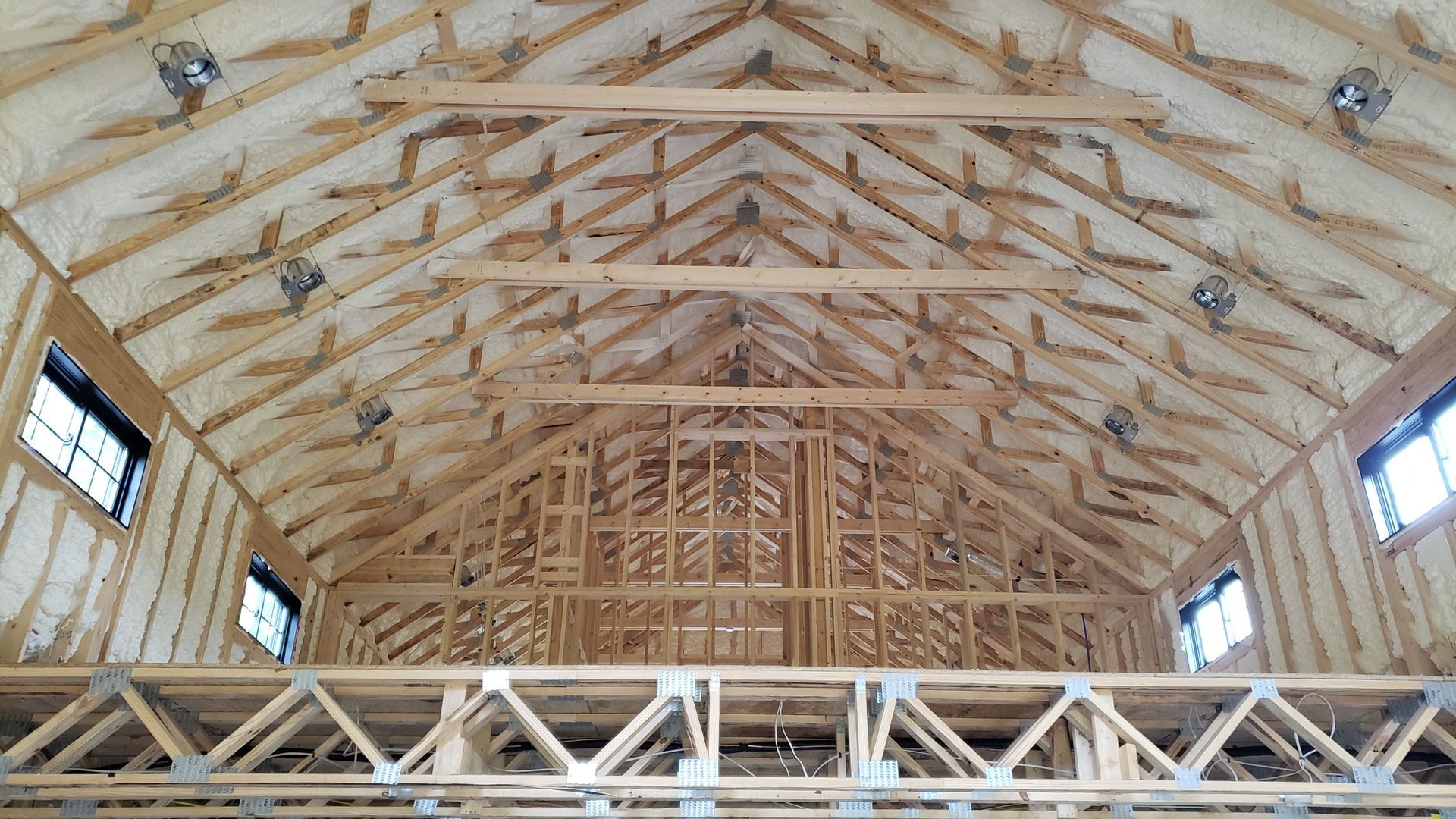 The ceiling of a building is being built and is covered in insulation.