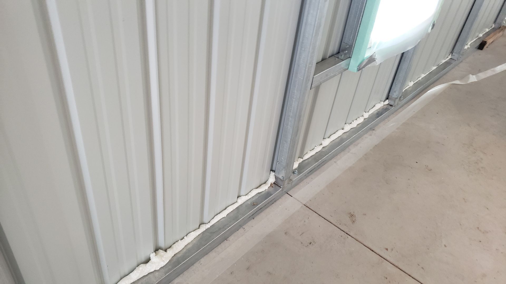 A close up of a metal wall with a light on it.