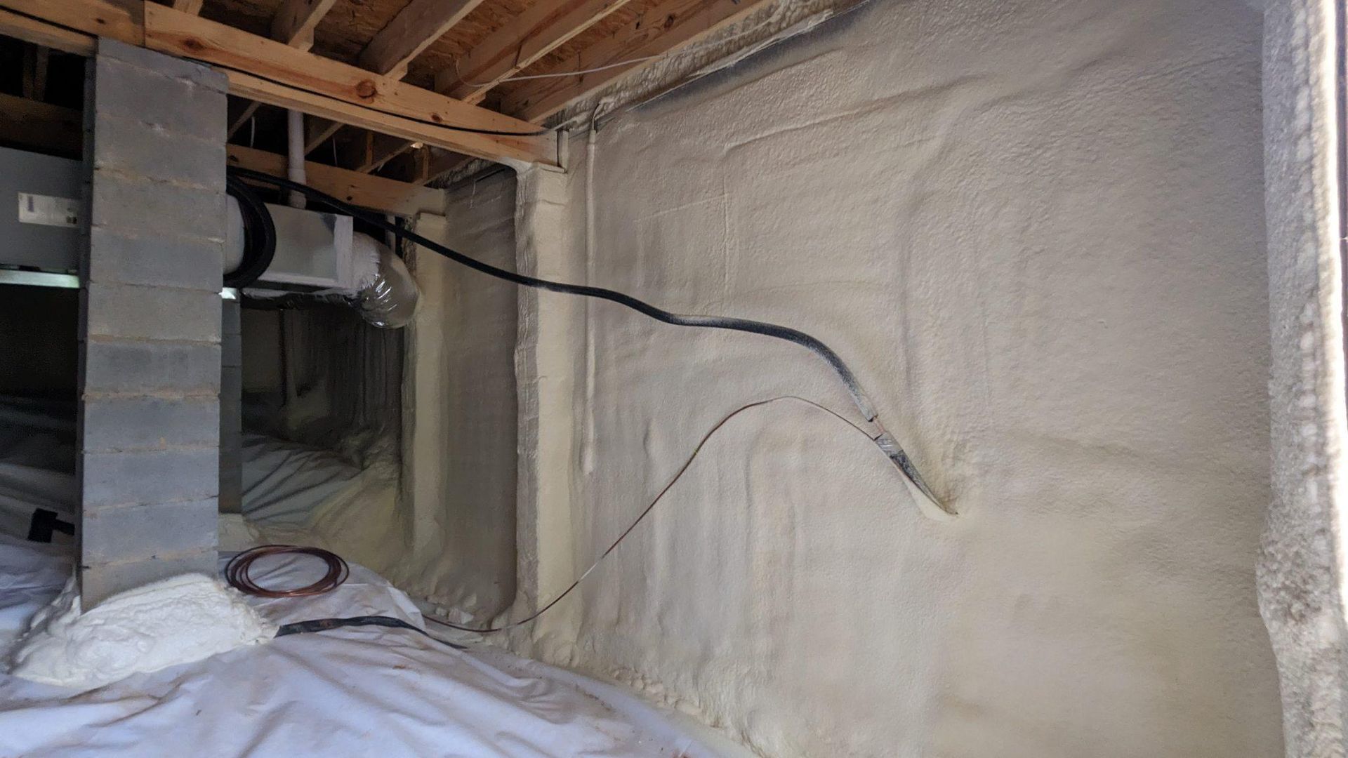 A room with a lot of foam on the wall and a fan.