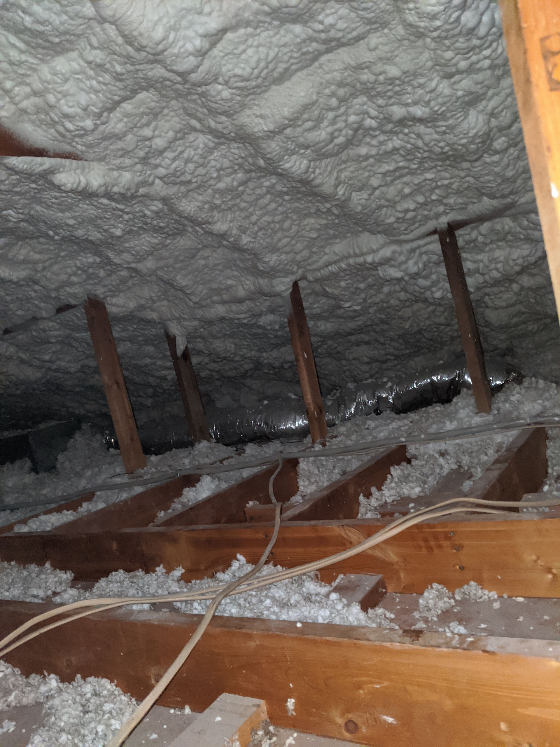 There is a lot of foam on the ceiling of the attic.